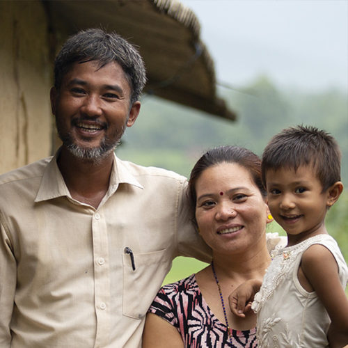 Smiling nepalese father, mother and daughter